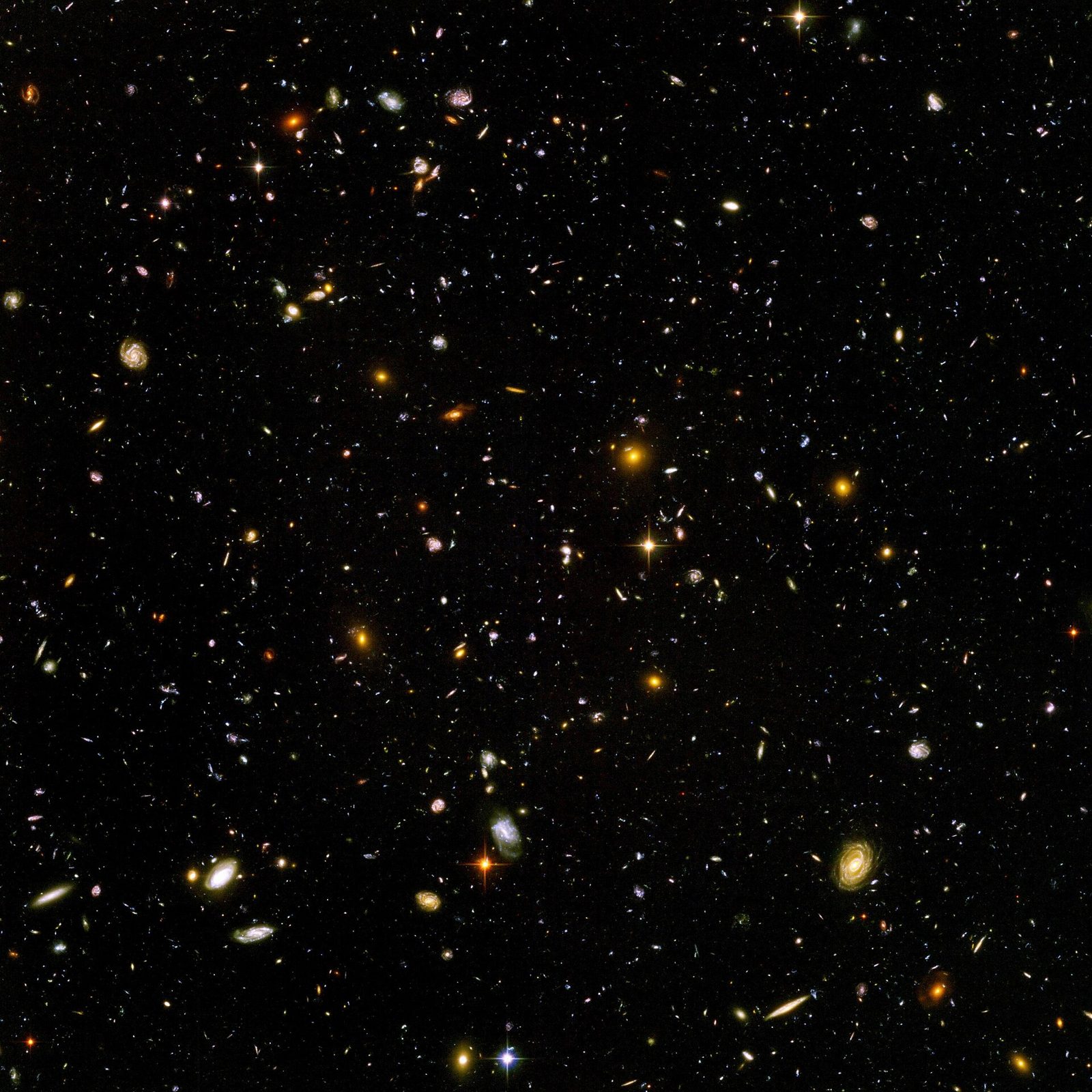 The Hubble Ultra Deep Field — a patch of black sky crowded with galaxies of every shape.